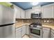 A bright kitchen showcases stainless steel appliances, including a range oven, microwave, and refrigerator at 6655 Flaminian Ln # 104, North Las Vegas, NV 89084