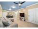 Open-concept living room with a comfortable sofa, tile flooring, and modern decor at 6655 Flaminian Ln # 104, North Las Vegas, NV 89084