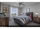 Comfortable secondary bedroom with a large window, neutral colors, and ample closet space at 6698 Nimbus Ave # Lot 17, Las Vegas, NV 89130
