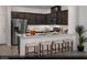 Modern kitchen featuring dark wood cabinets, stainless steel appliances, and a breakfast bar with seating at 6698 Nimbus Ave # Lot 17, Las Vegas, NV 89130