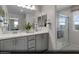Modern bathroom with double vanity, sleek cabinets, and glass-enclosed shower at 6716 Nimbus Ave # Lot 14, Las Vegas, NV 89130