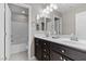 Bathroom featuring double sinks, tile flooring, and a tub with a shower at 6857 Stone Tower Ct, Las Vegas, NV 89149