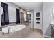 Modern bathroom showcasing a soaking tub, glass shower, and decorative tile work at 6857 Stone Tower Ct, Las Vegas, NV 89149