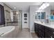Well-lit bathroom featuring a double sink vanity and a glass-enclosed shower at 6857 Stone Tower Ct, Las Vegas, NV 89149