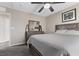 Neutral bedroom with a ceiling fan, window, bed, and a dresser with mirror at 6857 Stone Tower Ct, Las Vegas, NV 89149
