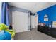 Comfortable bedroom with blue accent walls, closet, and carpeted floors at 6857 Stone Tower Ct, Las Vegas, NV 89149