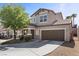 Inviting two-story home showcasing a well-kept yard, covered front porch with seating, and attached two car garage at 6857 Stone Tower Ct, Las Vegas, NV 89149