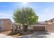 Attractive two-story home featuring desert landscaping, front porch seating, and a wide driveway leading to an attached garage at 6857 Stone Tower Ct, Las Vegas, NV 89149