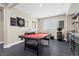 Entertaining game room with bar area, black tile flooring, a mounted dartboard, and red felt billiard table at 6857 Stone Tower Ct, Las Vegas, NV 89149