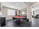 Spacious game room with black tiled floors, billiard table, wet bar, and an open layout with great flow at 6857 Stone Tower Ct, Las Vegas, NV 89149