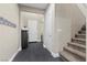 Entryway features dark wood-look floors, coat rack, and access to the stairs and front door at 6857 Stone Tower Ct, Las Vegas, NV 89149