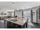 Open kitchen with stainless steel appliances, granite countertops, and a view of the backyard at 6857 Stone Tower Ct, Las Vegas, NV 89149