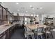 Spacious kitchen featuring dark wood cabinets, stainless steel appliances, and an island with a breakfast bar at 6857 Stone Tower Ct, Las Vegas, NV 89149