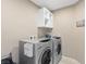 Laundry room with stacked washer and dryer and built in shelving at 6857 Stone Tower Ct, Las Vegas, NV 89149