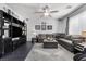 Cozy living room with a large sectional sofa, ceiling fan, and entertainment center at 6857 Stone Tower Ct, Las Vegas, NV 89149