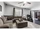 Open concept living area featuring a plush sectional, massage chair, and access to the kitchen at 6857 Stone Tower Ct, Las Vegas, NV 89149