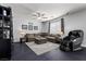 Inviting living room with comfortable sectional, ceiling fan, and accent furniture at 6857 Stone Tower Ct, Las Vegas, NV 89149