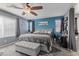 Cozy main bedroom features a ceiling fan, picture window and access to main bath at 6857 Stone Tower Ct, Las Vegas, NV 89149