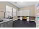 Bright office space with tiled floors, windows, and custom wall storage and countertop perfect for crafting at 6857 Stone Tower Ct, Las Vegas, NV 89149