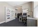 Functional office space with desk, computer, shelving, and sleek black tile flooring and neutral walls at 6857 Stone Tower Ct, Las Vegas, NV 89149