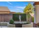 Landscaped backyard with a statue and seating for guests to relax at 7112 Rancho De Taos Ct, Las Vegas, NV 89130