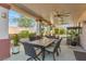 Covered patio with dining and seating area for entertaining and relaxing outdoors at 7112 Rancho De Taos Ct, Las Vegas, NV 89130