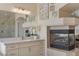 Bathroom featuring granite counters, shower and fireplace, plus decorative artwork at 7112 Rancho De Taos Ct, Las Vegas, NV 89130
