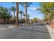 View of the gated entrance and landscaping of the community at 7112 Rancho De Taos Ct, Las Vegas, NV 89130
