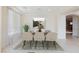 Elegant dining room with modern lighting, stylish decor, and large windows at 7112 Rancho De Taos Ct, Las Vegas, NV 89130
