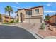 Charming two-story home with stone accents, balcony, and brick driveway at 7112 Rancho De Taos Ct, Las Vegas, NV 89130
