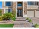 Inviting front entrance featuring brick walkway, stone accents, and lush landscaping at 7112 Rancho De Taos Ct, Las Vegas, NV 89130