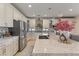 Beautiful kitchen featuring quartz countertops, stainless appliances, and breakfast bar at 7112 Rancho De Taos Ct, Las Vegas, NV 89130