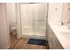 Bathroom features a glass enclosed shower with subway tile, a single sink, and wood look flooring at 7342 N Decatur Blvd # 5, Las Vegas, NV 89131