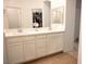 Primary bathroom offers dual sinks, white cabinets, an open closet, and wood look flooring at 7342 N Decatur Blvd # 5, Las Vegas, NV 89131