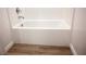 Clean, white tiled bathtub with chrome faucet and wood-look flooring at 7342 N Decatur Blvd # 5, Las Vegas, NV 89131