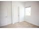 A well-lit bedroom with neutral carpet, a window with blinds, and a closet door at 7342 N Decatur Blvd # 5, Las Vegas, NV 89131