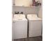 Functional laundry area includes a white washer and dryer set against a light gray wood look floor at 7342 N Decatur Blvd # 5, Las Vegas, NV 89131