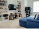 Well appointed living space features built in shelves, large screen television, comfortable seating and neutral carpet at 7342 N Decatur Blvd # 5, Las Vegas, NV 89131