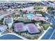 Community aerial view featuring tennis and basketball courts, pool, and playground for active recreation at 7404 Eggshell Dr, North Las Vegas, NV 89084