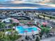 Aerial shot of community amenities featuring swimming pool, tennis courts, playground, and scenic landscaping at 7404 Eggshell Dr, North Las Vegas, NV 89084
