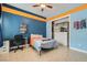 Bedroom with a desk, bed, and closet with custom shelving and blue and orange paint at 7404 Eggshell Dr, North Las Vegas, NV 89084