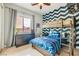 Cozy bedroom featuring a bunk bed, blue Fortnite bedding, and stylish chevron accent wall at 7404 Eggshell Dr, North Las Vegas, NV 89084