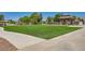 Beautiful common area with lush green space, walking path, and covered picnic area for community enjoyment at 7404 Eggshell Dr, North Las Vegas, NV 89084