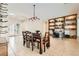 Inviting dining room with elegant lighting, a large table, and custom built-in shelving at 7404 Eggshell Dr, North Las Vegas, NV 89084