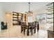 Well-lit dining area featuring built-in bookshelves and a view of the backyard at 7404 Eggshell Dr, North Las Vegas, NV 89084