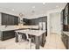Modern kitchen with stainless steel appliances, a spacious island, and dark cabinetry at 7404 Eggshell Dr, North Las Vegas, NV 89084