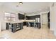 Spacious kitchen features stainless appliances, a breakfast bar, a kitchen island, and tiled flooring at 7404 Eggshell Dr, North Las Vegas, NV 89084
