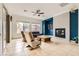 Bright living room boasts a modern fireplace, neutral tones, and ample natural light at 7404 Eggshell Dr, North Las Vegas, NV 89084