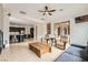 Open-concept living area with tile floors, comfortable seating, and seamless kitchen access at 7404 Eggshell Dr, North Las Vegas, NV 89084