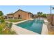Inviting pool and backyard with lush greenery and a covered patio area at 7404 Eggshell Dr, North Las Vegas, NV 89084